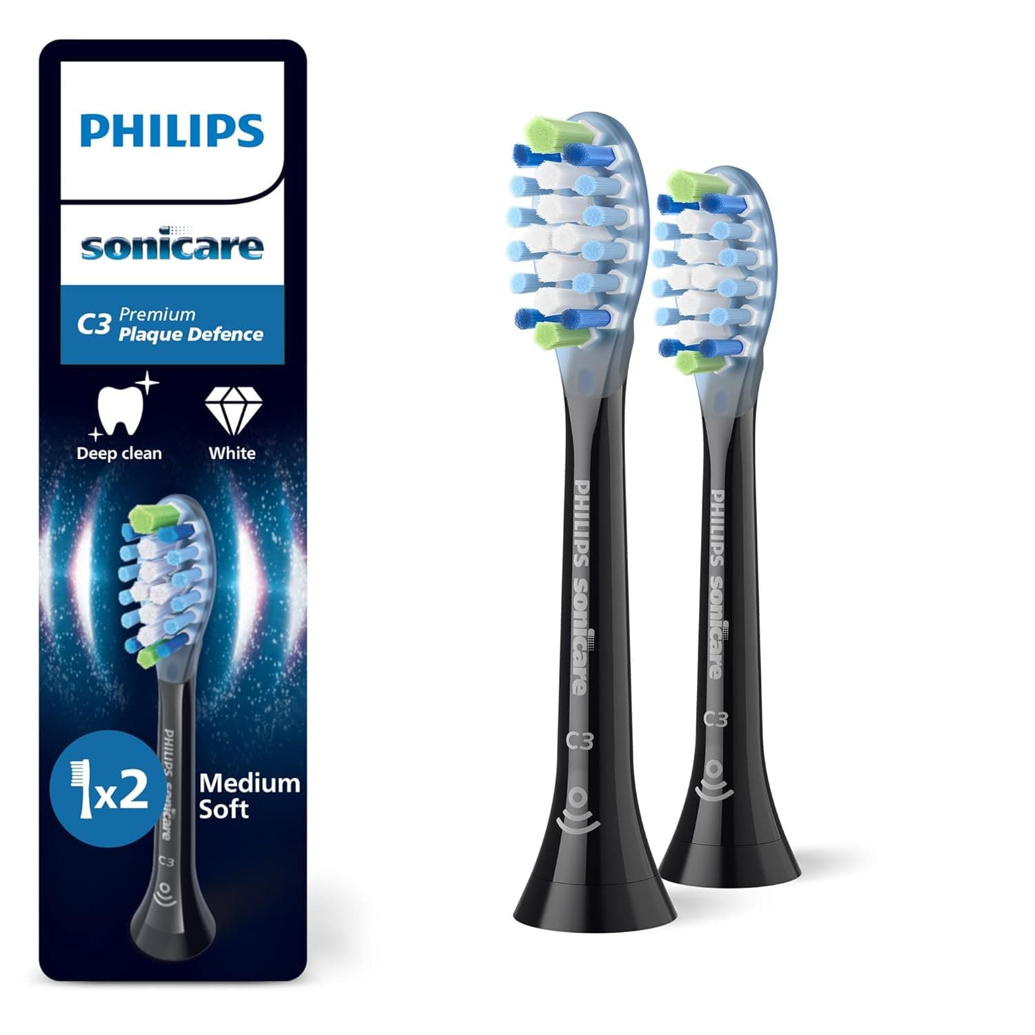 Zwei schwarze Aufsteckbürsten mit hellen Borsten und blauen und grünen Akzenten, daneben die dunkle Blisterpackung mit der Aufschrift Philips Sonicare, C3 Premium Plaque Defence, Deep clean, White, 1 mal 2 und Medium Soft