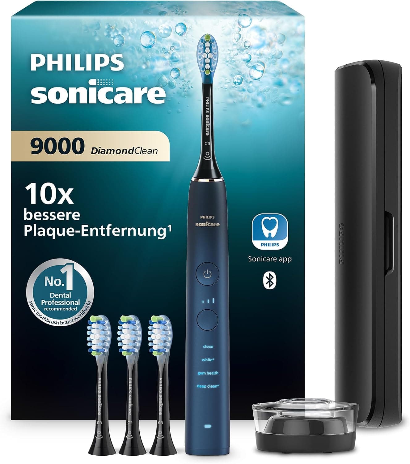 Dunkelblaue Philips-Sonicare-Zahnbürste der 9000er Serie vor ihrem dunklen Karton, daneben drei schwarze Aufsteckbürsten, ein schwarzes Reiseetui und eine runde Ladestation aus Glas