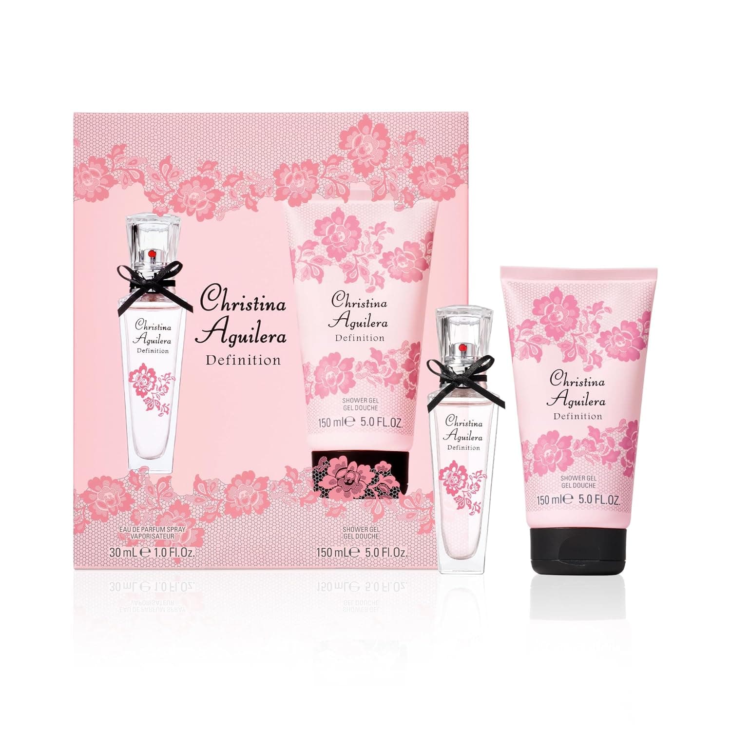 Rosa Geschenkschachtel mit Spitzenmuster, davor der Flakon mit schwarzer Schleife und die rosa Duschgel-Tube, beide mit der Aufschrift Christina Aguilera Definition
