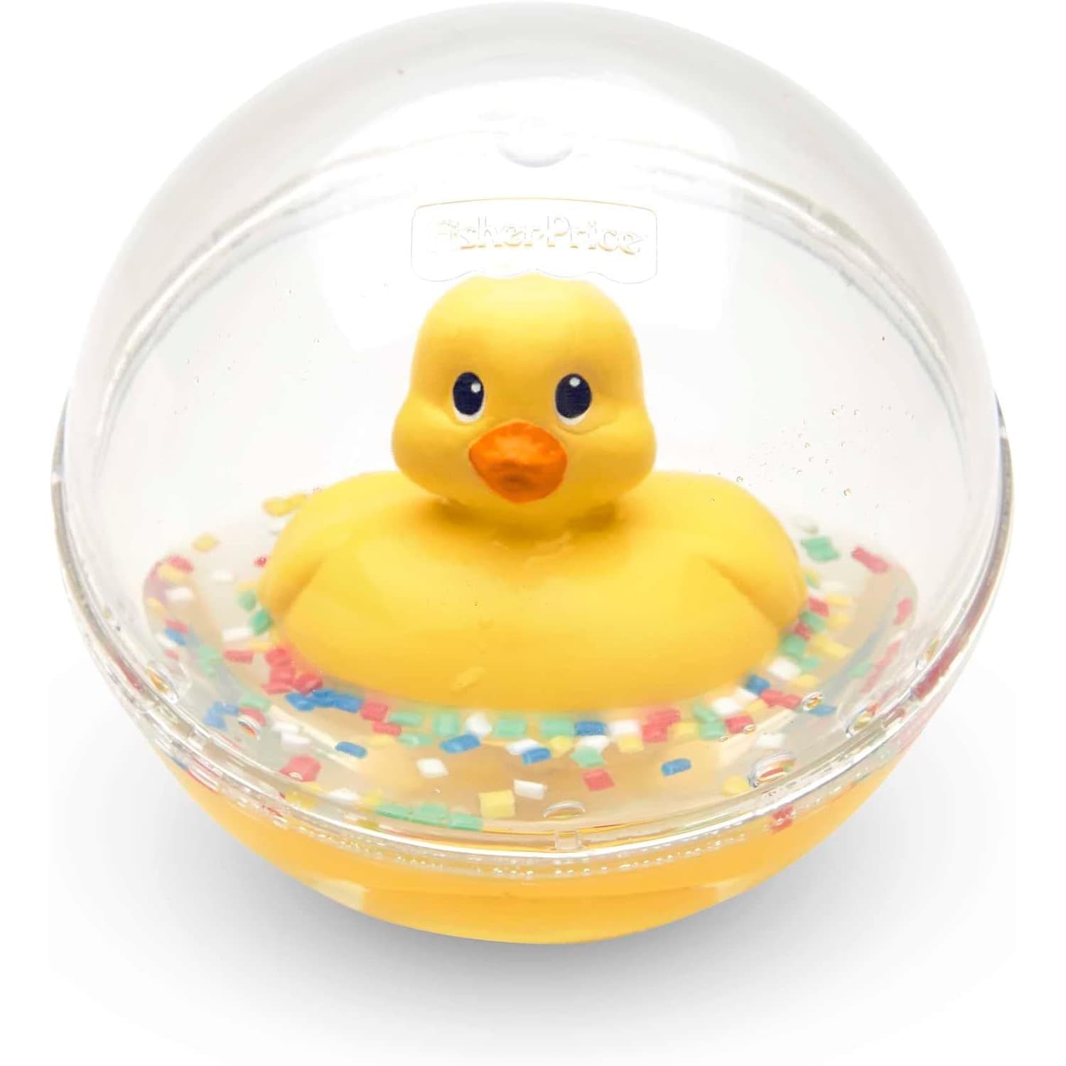 Durchsichtige Kunststoffkugel mit Fisher-Price-Prägung, darin eine gelbe Ente mit orangem Schnabel auf Wasser und buntem Konfetti